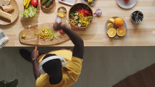 Overhead View: Person Preparing Salad in Kitchen