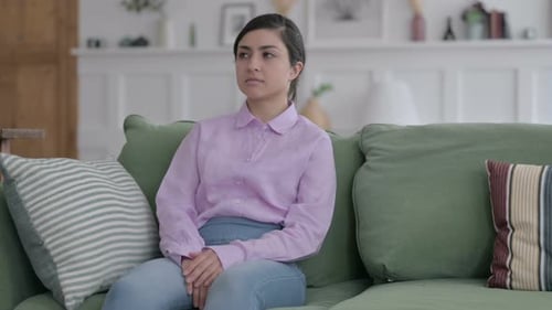 Indian Woman Sitting on Sofa Thinking