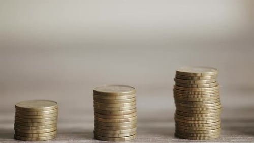 Up Trend in Stock Market Depicted By Stacks of Coins Growth and Financial Chart As the Back