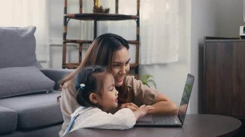 Woman and Child Using Laptop at Home