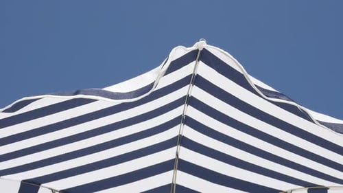 Fabric of umbrella made for protection from the sun slow motion 1080p FullHD footage - Beach strip