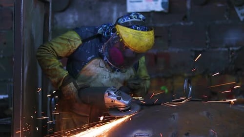 Worker Grinding Metal with Protective Gear