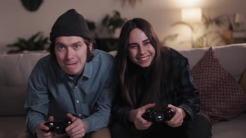 Happy Couple Playing Video Games on Couch Together