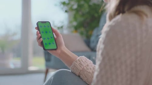 Young Adult with Green Screen Mobile Phone Indoors