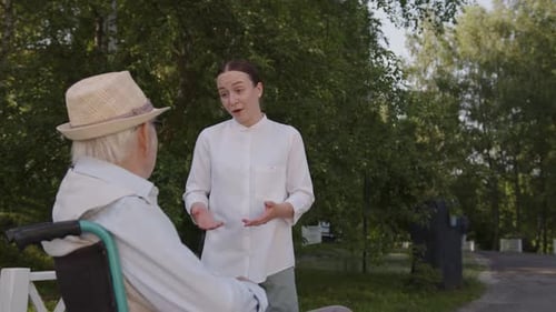 Young Nurse Talks with Her Old Patient