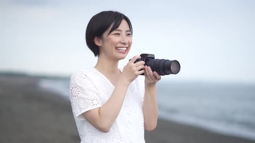 Woman Takes Photos at the Beach with Digital Camera