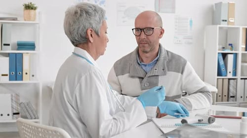 Doctor Giving Adult Man a Throat Swab