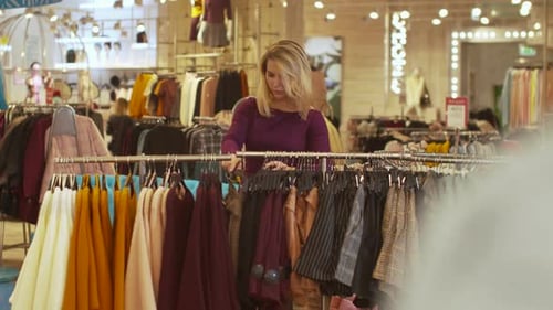 Junge Frau wählt Shorts im Laden