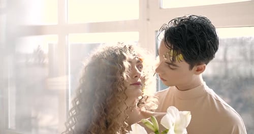 Tendet Young Couple with Floral Make Up Pose in Studio