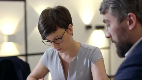 Experienced Business Man and Woman Discussing Contract