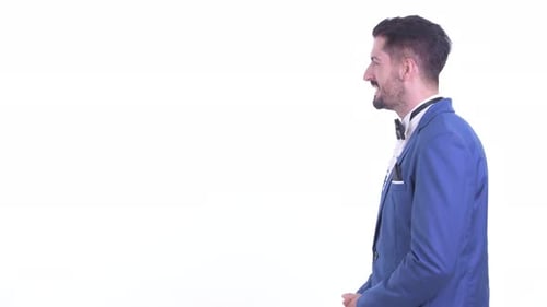 Profile View of Happy Young Handsome Bearded Businessman Talking