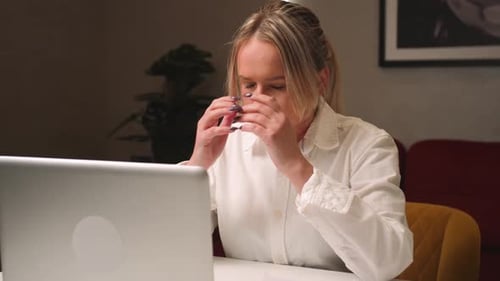 Tired Sad Businesswoman Working and Looking at Laptop at the Home Office