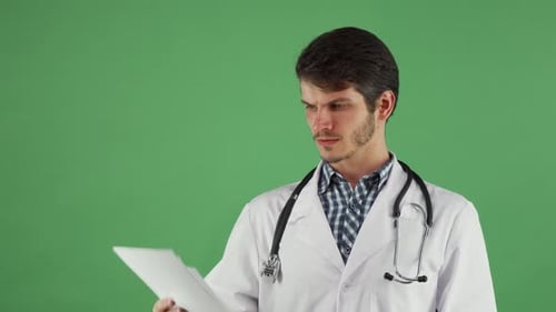 Doctor Examining Documents on Green Screen