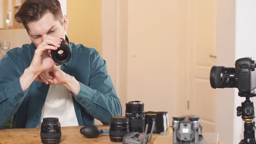 Man Explaining Camera Lens With Photography Equipment