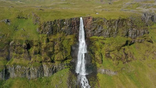 Aerial Drone Footage of Bjarnarfoss Waterfall with Its Green Cliffs in Western Iceland