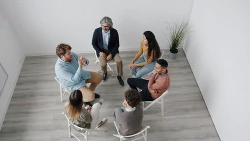 Group Meeting in a Bright Room with White Walls