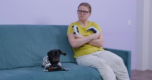 Adult and Dog Sit with Video Game Controllers