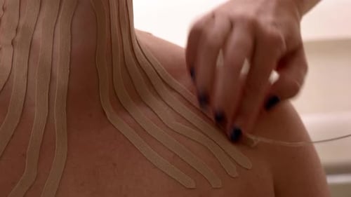 Receiving Kinesiology Tape for Pain Management