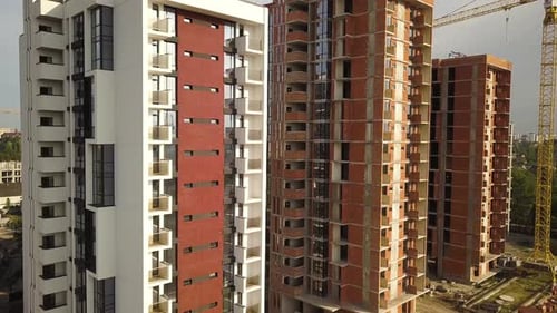 Aerial view of tall residential apartment buildings under construction. Real estate development.