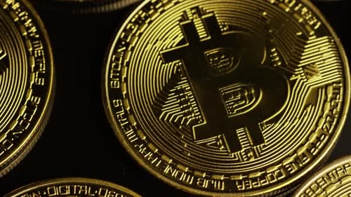 Rotating shot of Bitcoins (digital cryptocurrency) - BITCOIN