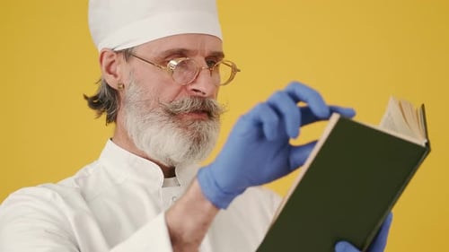 Senior Medical Professional Reading Medical Book