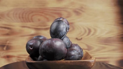 Fresh Plums in a Wooden Bowl
