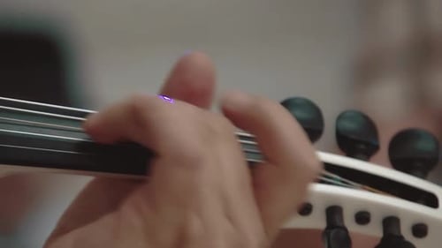 Close-Up of Hand Playing an Electric Violin