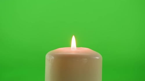 Burning Wax Candle on Green Chroma Key Background