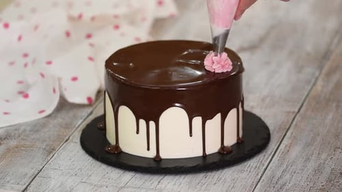 Decorating Cake with Chocolate Glaze and Pink Icing