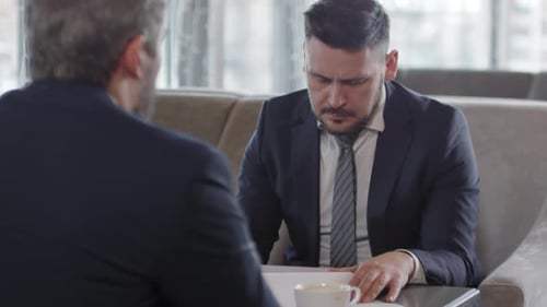 Businessmen Discussing Strategy in Modern Workplace Setting