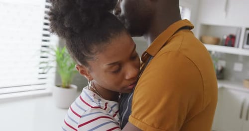 Loving Couple Embracing in a Bright Kitchen