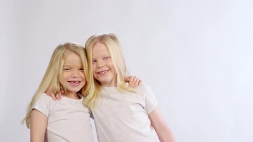 Two Happy Blonde Girls Hugging