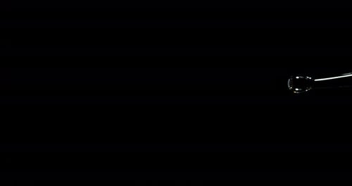 Water Splash Flowing Across Black Background