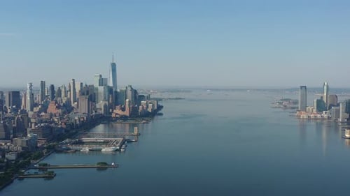 A drone view over the Hudson River early in the morning. The camera truck right high over the calm r