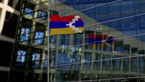 Artsakh National Flag Waving in Front of Modern Building