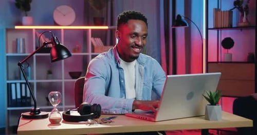 African American Sitting at His Workplace in Home Office
