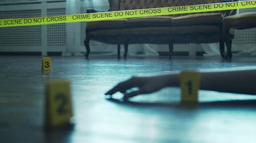 Crime Scene Hand With Evidence Markers and Tape