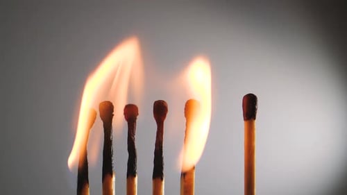 Close Up of Five Matches Heads Burning