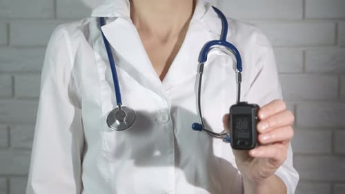 Medical Professional Holding Pulse Oximeter