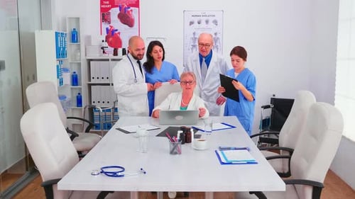 Medical Team Reviewing Patient Data on Laptop