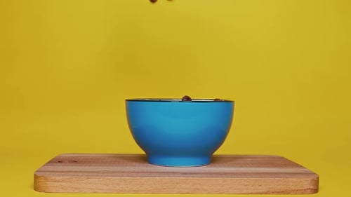 Close Up of Cereal Pouring Into a Bowl at Breakfast in Slow Motion