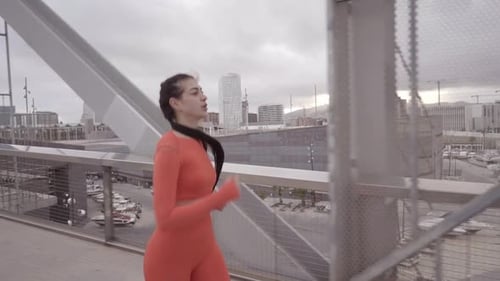 Fit Woman Running on City Street Training Intense Cardio Endurance Workout Focused Female Runner