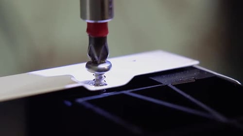 Master, Who Manufactures Furniture Sets the Dishwasher, Using a Screwdriver. Close-up. Slow Motion