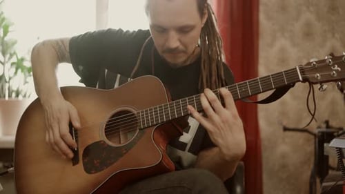 Man Playing Acoustic Guitar in Natural Light