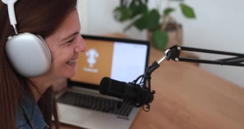 Woman Speaking Into Microphone with Headphones