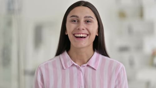 Portrait of Young Latin Woman Saying Yes By Shaking Head