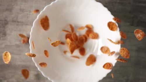 Breakfast Cereal Falling into a White Bowl