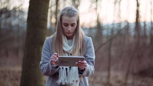 Woman Using Digital Tablet in Park