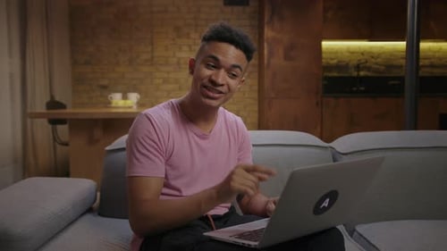 Young Man Smiling During a Video Call at Home
