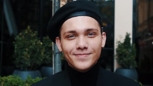 Close-up Portrait of a Young Handsome Man. Smiling and Looking at the Camera. Beautiful People, City